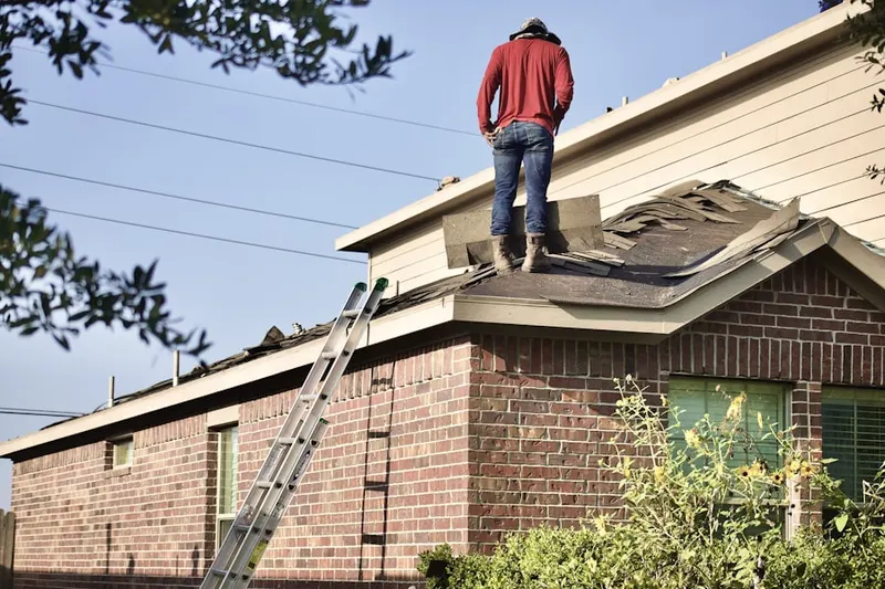 Professional roofer working on a residential roof in Whitewater